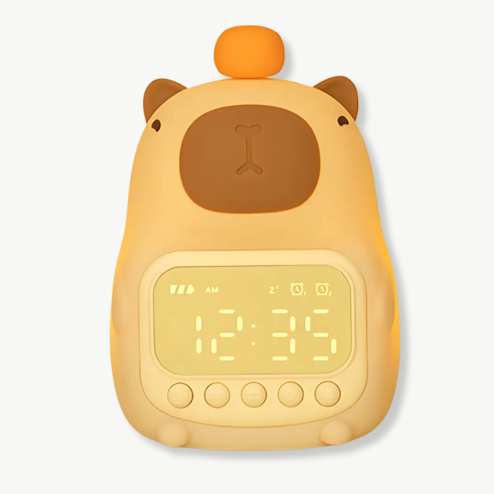 Budzik w kształcie kapibary z podświetleniem LED na stoliku nocnym