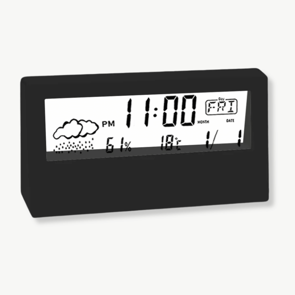 Budzik LCD z termometrem i higrometrem w kolorze czarnym na szafce nocnej